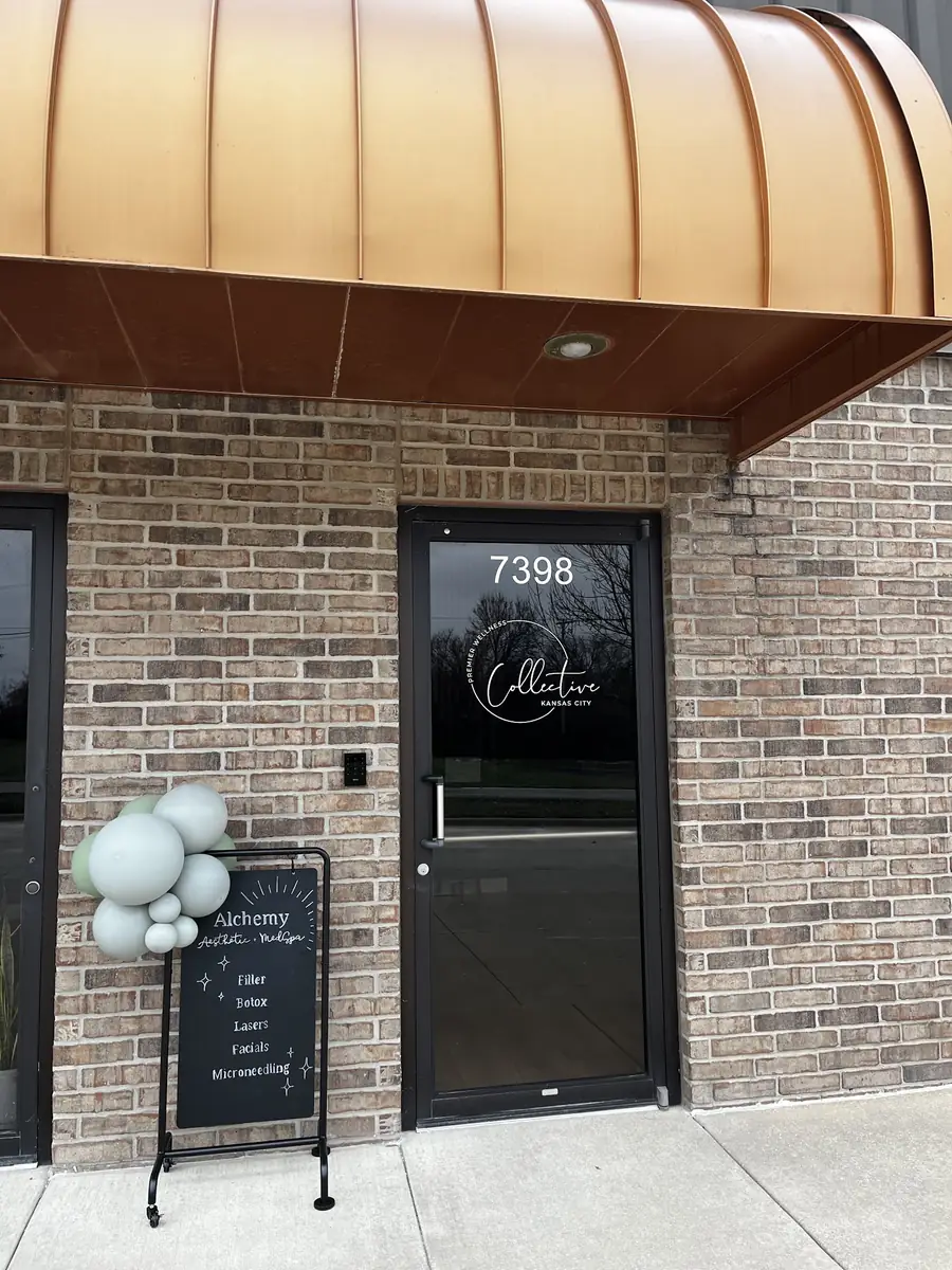 The entrance to the building at 7398 with the Alchemy sign outside the door.